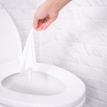 flushable wipes wipe being put into toilet og